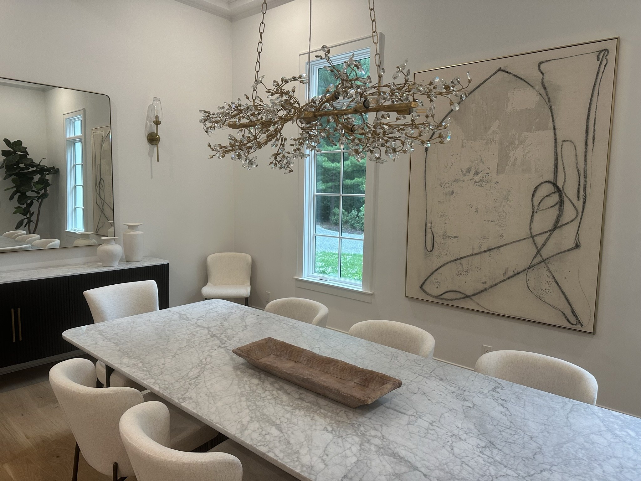 Modern dining with branch chandelier